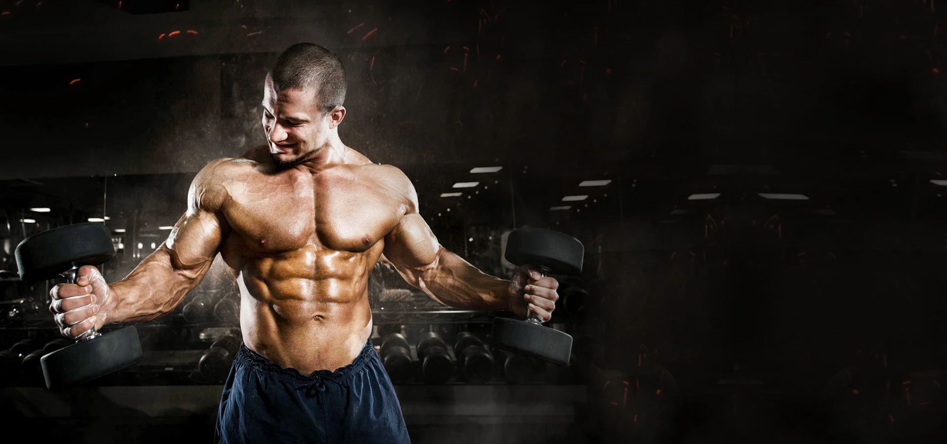 Bodybuilder training with dumbbells